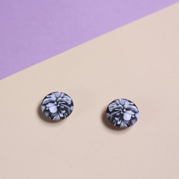 Elegant floral brooch with intricate black and white pattern, suitable for formal or casual wear.