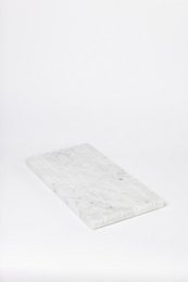 Rectangular marble tray for product display, with a smooth, polished surface.