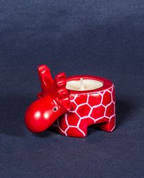 A red, patterned ceramic candle holder in the shape of a moose, made of soapstone.