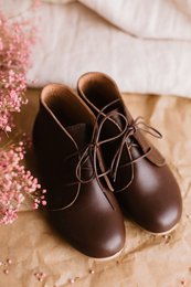  Handmade leather girls' ankle boots in chocolate brown color, available in sizes 22-30. The boots feature a lace-up design and a classic style suitable for casual wear.