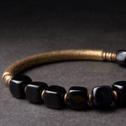 Bracciale a blocchi di ossidiana nera con bracciale rigido in bronzo