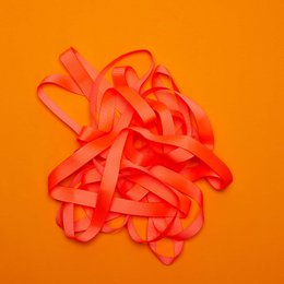 Vibrant neon orange ribbon with "My Pretty Circus" text. Ideal for gift wrapping, crafting, and decorating.
