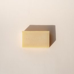 A solid face cleanser with prickly pear, a yellow bar of soap with the brand name "FIG" printed on it.