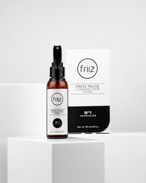 Transparent bottle with black spray nozzle, containing a clear liquid. The label on the bottle displays the brand name "Frio" and indicates that the product is a sneaker and textile sealing agent.