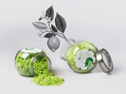 Natural soap flakes with lime essential oil, green and white color, bar soap, and jar with green contents.