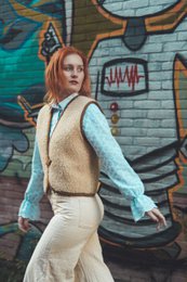 Beige woolen bodywarmer with button closure, suitable for women's casual wear.