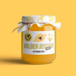 Golden spread made from lemon curd, with a bright yellow color and a decorative ribbon on the jar.