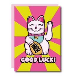 A greeting card featuring a white cat with a red bow and a raised paw, with the text "Good Luck!" on a pink and yellow background.