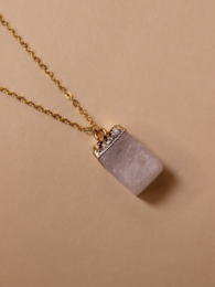 A delicate gold-toned necklace with a rectangular lavender-colored stone pendant and a round clear stone pendant.