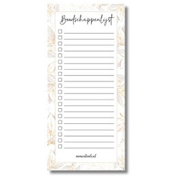 A to-do list notepad with the title "Birthday shopping list" in a minimalist, handwritten style. The notepad is placed on a wooden tray with a candle and other decorative elements.