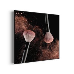 Makeup brushes in a dark background with sparkling powder. The brushes appear to be square-shaped and made of natural materials.