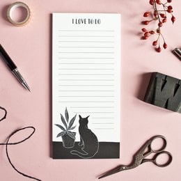 A notepad with a silhouette of a cat and a potted plant, perfect for jotting down notes and to-do lists.