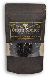 Black tea with orange blossoms. Dark tea leaves with dried orange slices and petals.