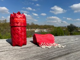 Warm poppy red scarf with woven texture and fringe details.
