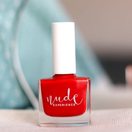 Vibrant red nail polish with a minimalist design. Made from bio-sourced ingredients.