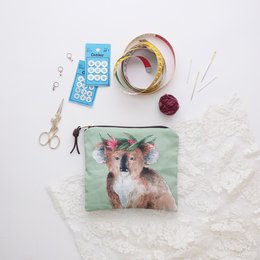  A small zipper pouch or coin purse featuring a colorful illustration of a koala. The pouch is made of a soft, textured material and has a zipper closure. It appears to be a versatile storage item that could be used for various purposes.