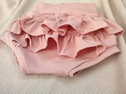 Powder pink bloomers with ruffled details, perfect for baby girls. Made of soft, comfortable fabric in sizes newborn to 24 months.
