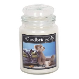 A large, round, white scented candle in a glass jar with a label that says "Woodbridge" and features an image of a teddy bear. The candle is described as "Clean Linen" scented and weighs 565g.
