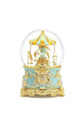 Turquoise and gold snow globe with Swarovski crystals. Decorative glass dome with carousel-style base and intricate floral design.