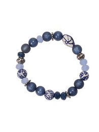  A bracelet made of blue beads with a floral pattern. The bracelet features round, dark blue beads with a matte finish, interspersed with beads with a floral design in white and blue.