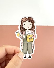Cute girl sticker with brown hair, white cardigan, green dress, yellow lemon bag illustration.