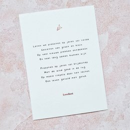 A white greeting card with a handwritten message in black text that reads "Cheers to another year around the sun. May your day be filled with laughter, love, and all the things that make you smile."