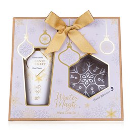  A winter-themed hand care gift set in a decorative box. The set includes a hand cream and a decorative snowflake-patterned item, likely a soap or bath product. The packaging features a gold bow and winter-inspired graphics.