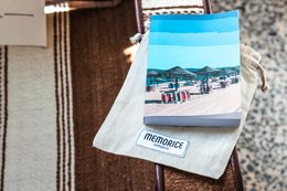A6 notebook with a scenic landscape image on the cover, featuring a wooden background and a blue and orange color scheme.