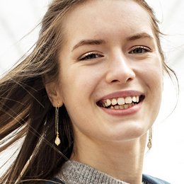 Elegant drop earrings with teardrop-shaped crystal pendants in a gold-tone finish.