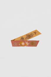 Gold and red floral patterned ribbon scarf with a bow detail.
