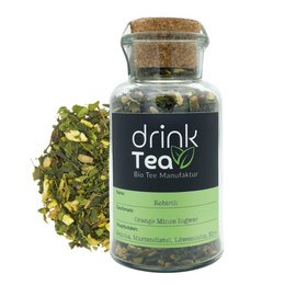 Organic Superfood Tea Rebirth Cork Glass - A glass tea container filled with a green tea blend, featuring a cork lid and a black and green label.
The image shows a glass container filled with a green tea blend. The container has a cork lid and a black and green label that says "drink tea". The tea blend appears to be a mix of green tea leaves and other dried herbs or botanicals.
