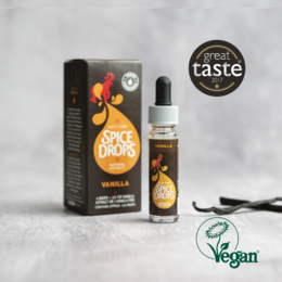 Vanilla natural extract, vegan, award-winning spice drops in a glass bottle with a dropper. The product is displayed on a wooden surface with various spices and ingredients.