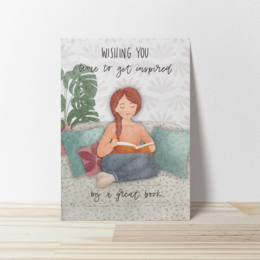  A greeting card with a watercolor illustration of a woman reading a book, with the text "Wishing you a good adventure" written on the cover.