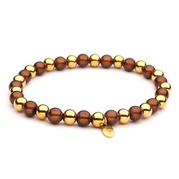 Stainless steel bracelet with gold and brown beads. Beaded bracelet in a mix of metallic and natural tones.