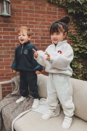  Cozy kids' sweatsuit set in navy blue and grey, featuring a sherpa-lined jacket and matching pants.