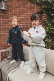Cozy kids' sweatsuit set in navy blue and grey, featuring a sherpa-lined jacket and matching pants.