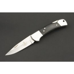 A paring knife with a buffalo horn handle and a 440C stainless steel blade. The knife has a classic design and is suitable for a variety of kitchen tasks.