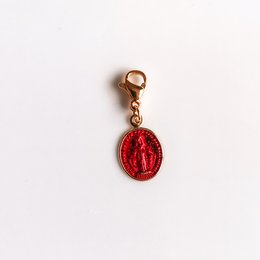 Red Miraculous Medal pendant with a round, red enamel charm featuring a religious symbol.