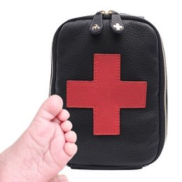 Black first aid pouch with red cross symbol, designed for parents to carry essential medical supplies for their children.
