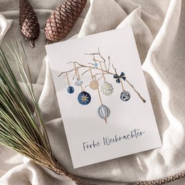 Minimalist Christmas card with hanging ornaments, branch, blue and silver baubles, festive holiday greeting design.