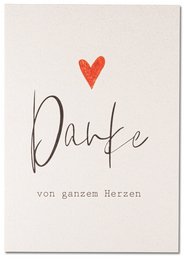 A simple yet elegant thank you card with a handwritten "Danke" (German for "Thank you") and a small red heart, conveying a heartfelt message.