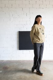 Beige oversized sweatshirt with black pants. Casual, comfortable outfit for everyday wear.