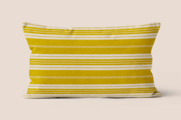 Striped cushion in beige, yellow, and white colors. Rectangular shape, soft and comfortable material.