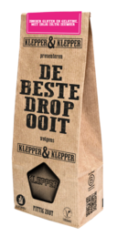 Spicy salt licorice in a brown paper bag with the text "De Beste Drop" (The Best Licorice) and a licorice candy icon.