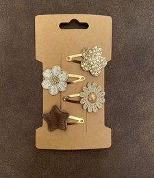 Set of 78 hair clips for kids, featuring floral and star-shaped designs in a variety of colors and materials.