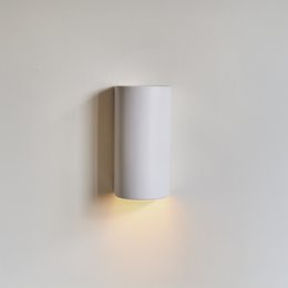 Elegant, minimalist white ceramic wall sconce with up and down lighting for a Japandi-inspired look.