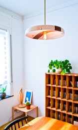 Hanging lamp 'Sky' - a modern, round pendant light with a warm, glowing center and a wooden frame.