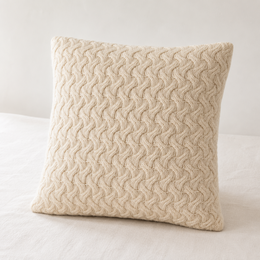 Beige knitted throw pillow with textured cushion cover in an urbane hide design.
