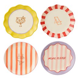 Assorted breakfast plates in various colors and patterns, including a yellow and orange plate with a cat design, a red and white striped plate, and a plate with the text "MORE PLEASE" on it.