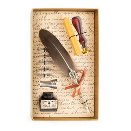 Luxe calligraphy ink set with wax seal in light golden box. Includes feather quill, ink bottle, and wax seal. Ideal for writing, journaling, and artistic expression.